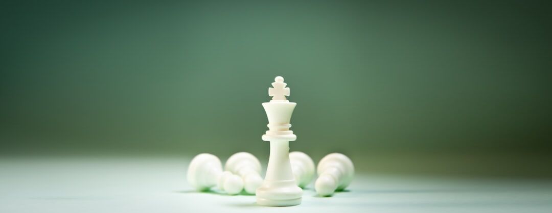 chessboard with business pieces in strategic positions