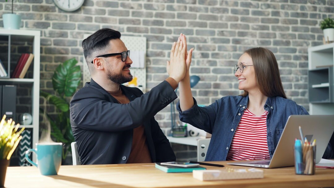 business team high fiving in office